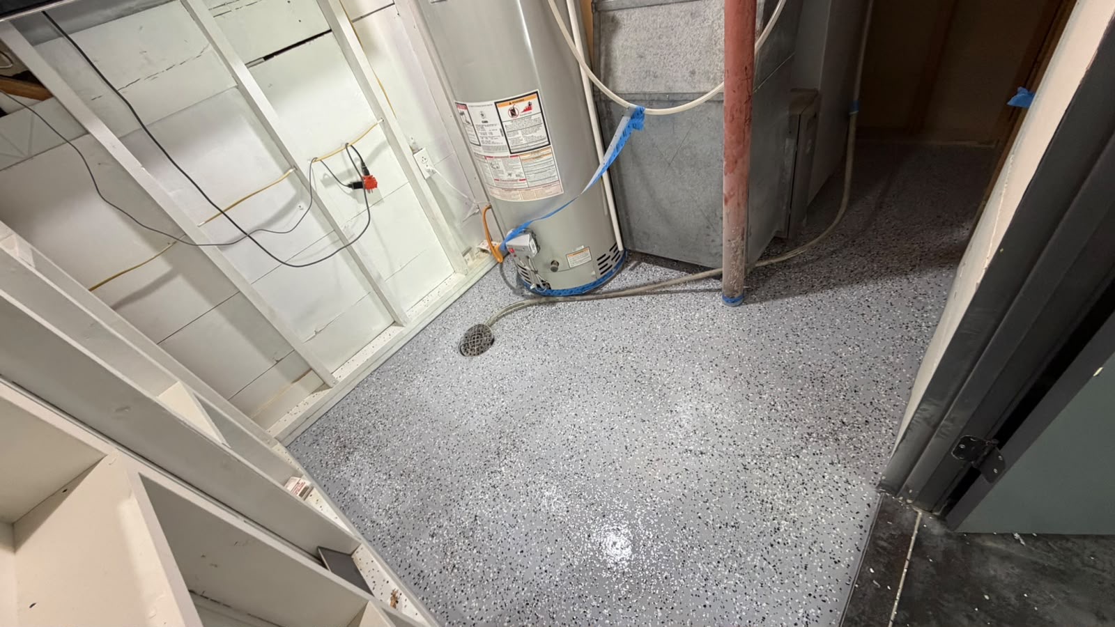 Finished speckled epoxy floor coating in a basement